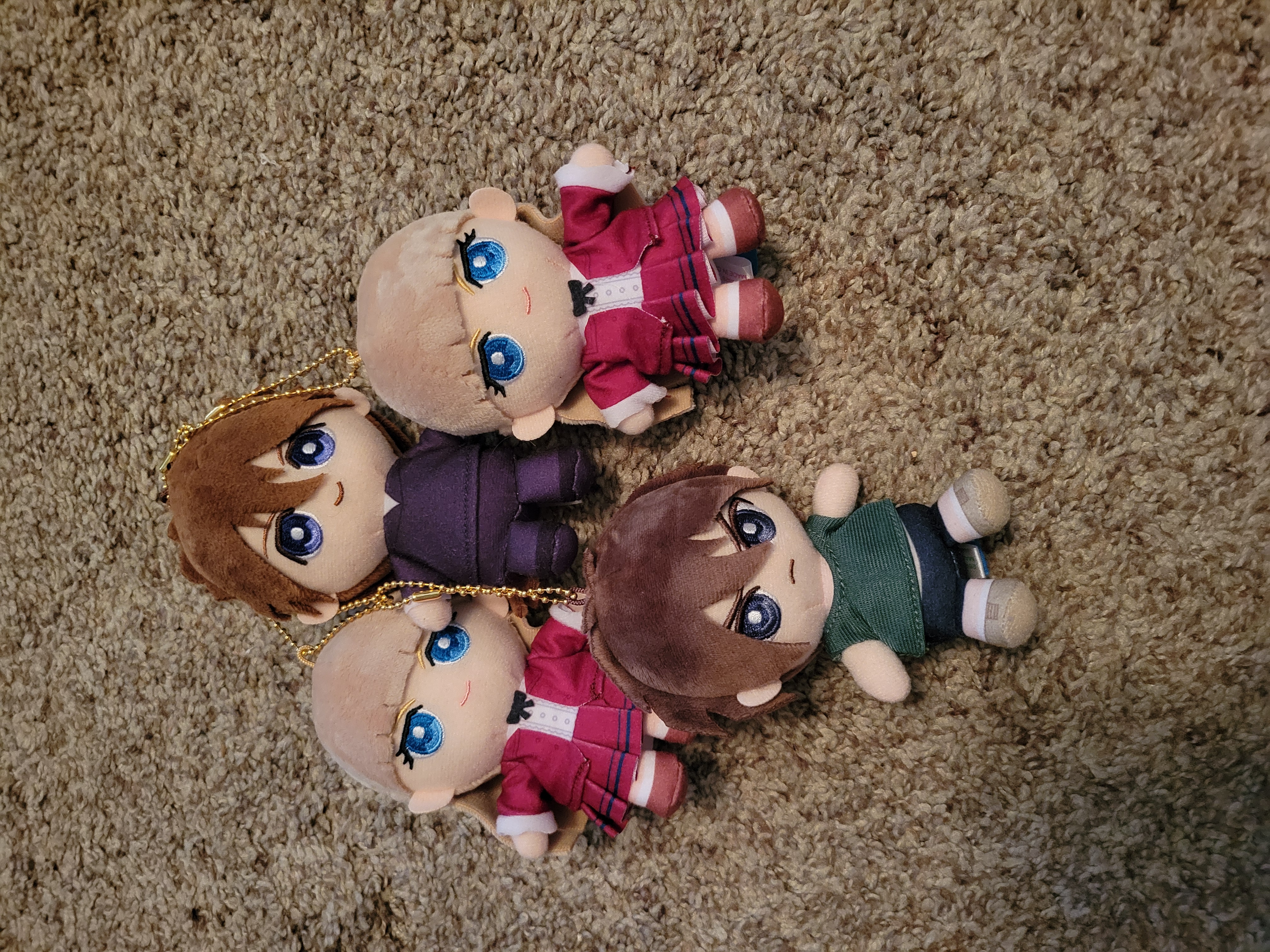Two Relena, one Heero and Duo plush chained together on the carpet.